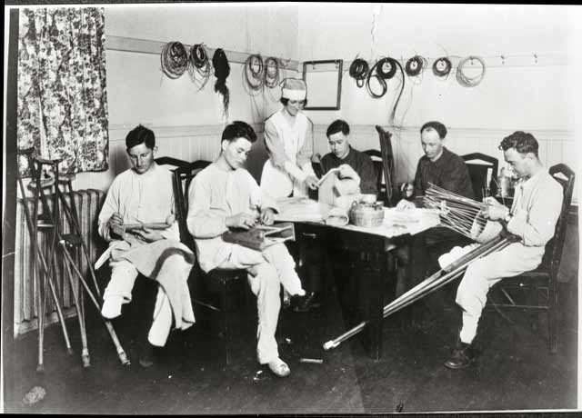 Wounded soldiers at General Hospital 29 learning crafts, 1919, illustrating recovery efforts.